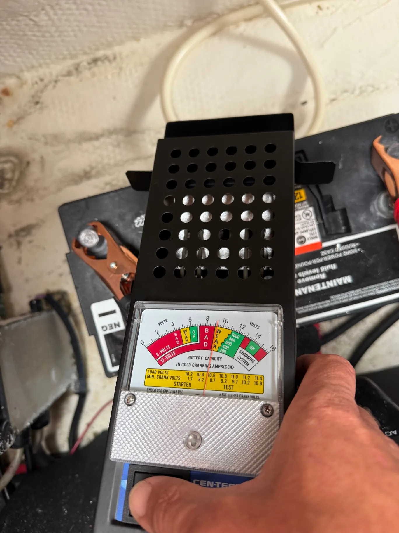 Battery load tester checking a marine battery during an electrical service