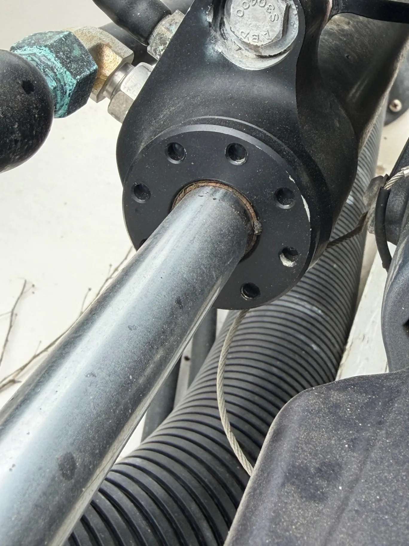 Corrosion and salt buildup on an outboard steering pivot and grease fitting