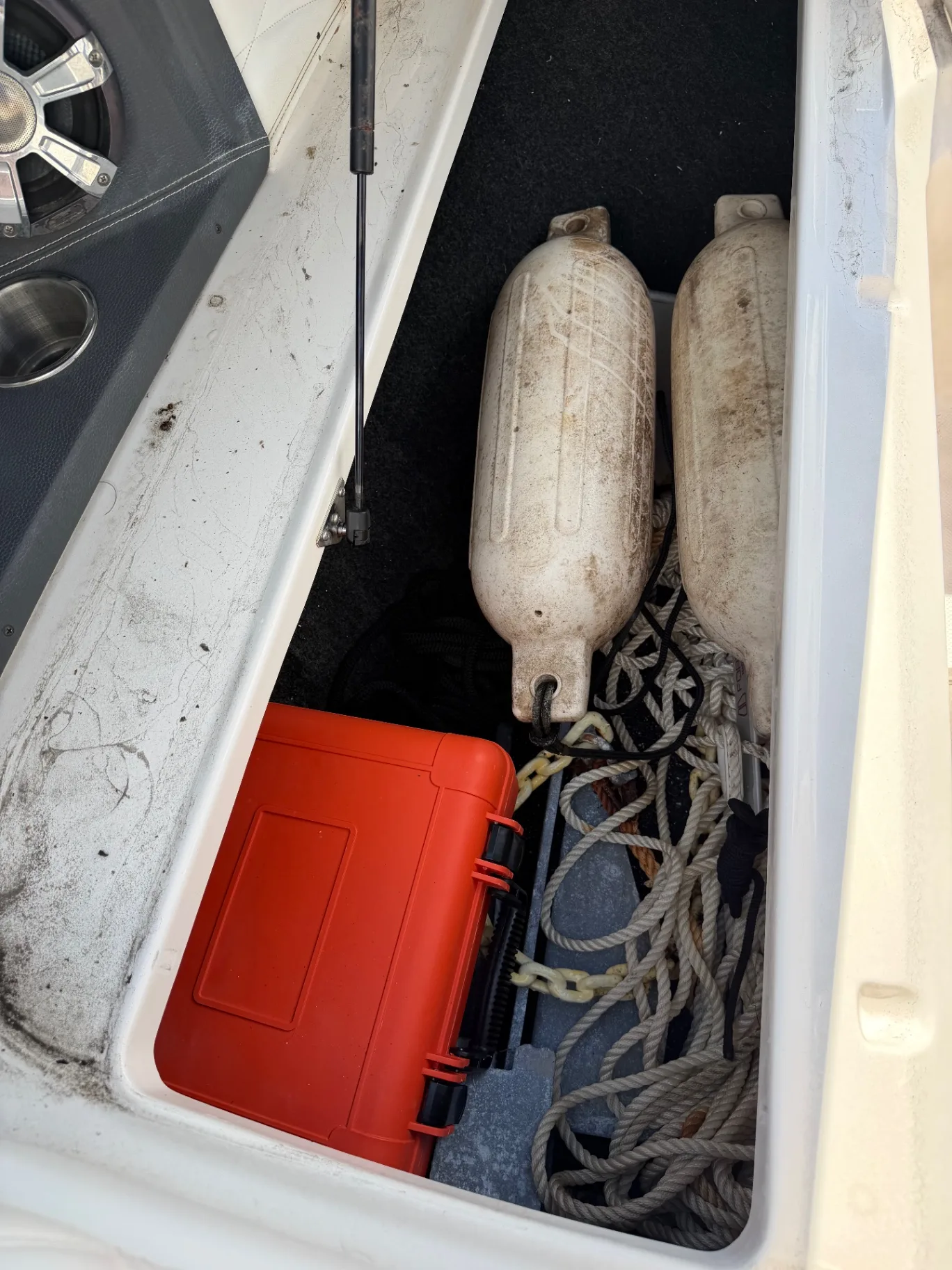 Twin white outboards on a boat transom at a sunny marina