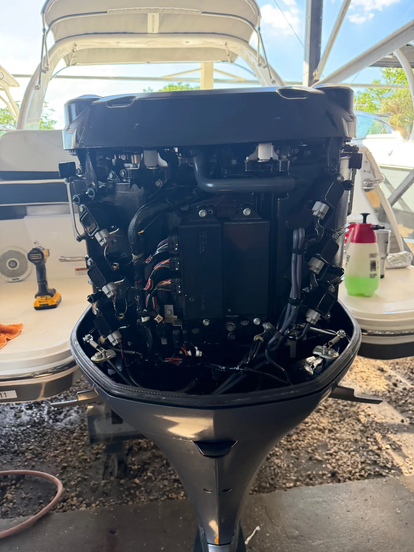 Outboard powerhead with cowling removed during engine service